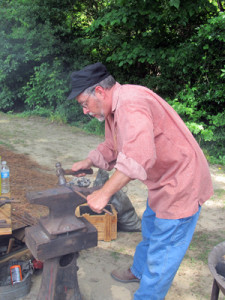 Blacksmith using anvil